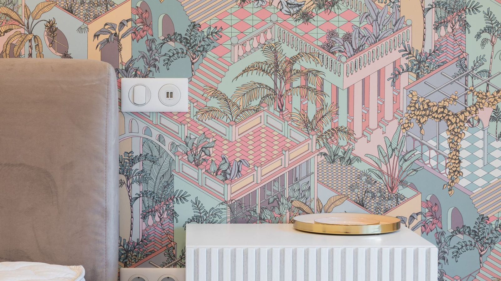 A bright bedroom with a bold tropical peel and stick accent wall