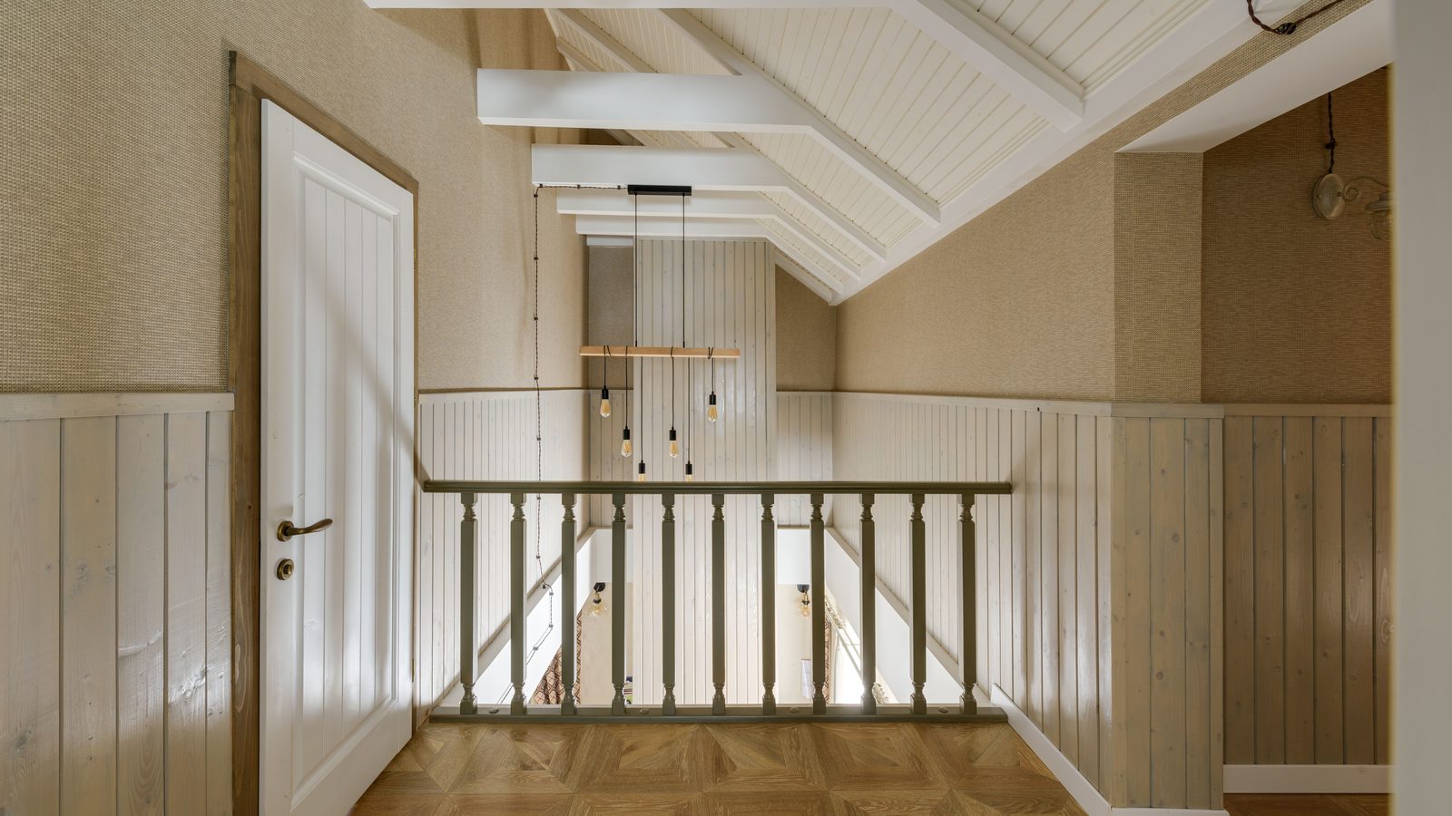 A landing with vertical-board wainscoting run to a top rail around three walls